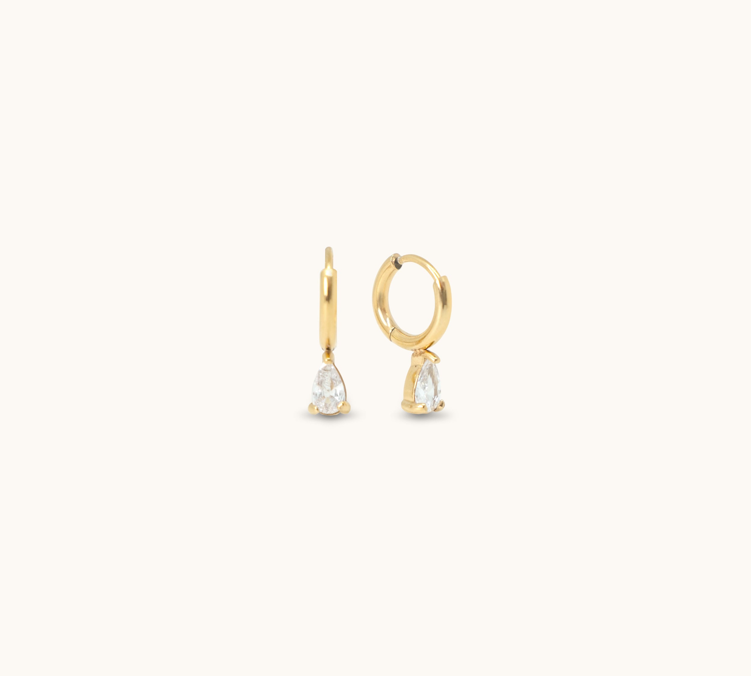 Small, "huggie" hoop style earrings with a drop cubic zirconia stone. 