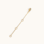 A gold-plated extender chain with multiple jump rings to adjust the length and a clasp at one end.