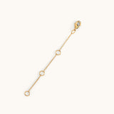 A gold-plated extender chain with multiple jump rings to adjust the length and a clasp at one end.