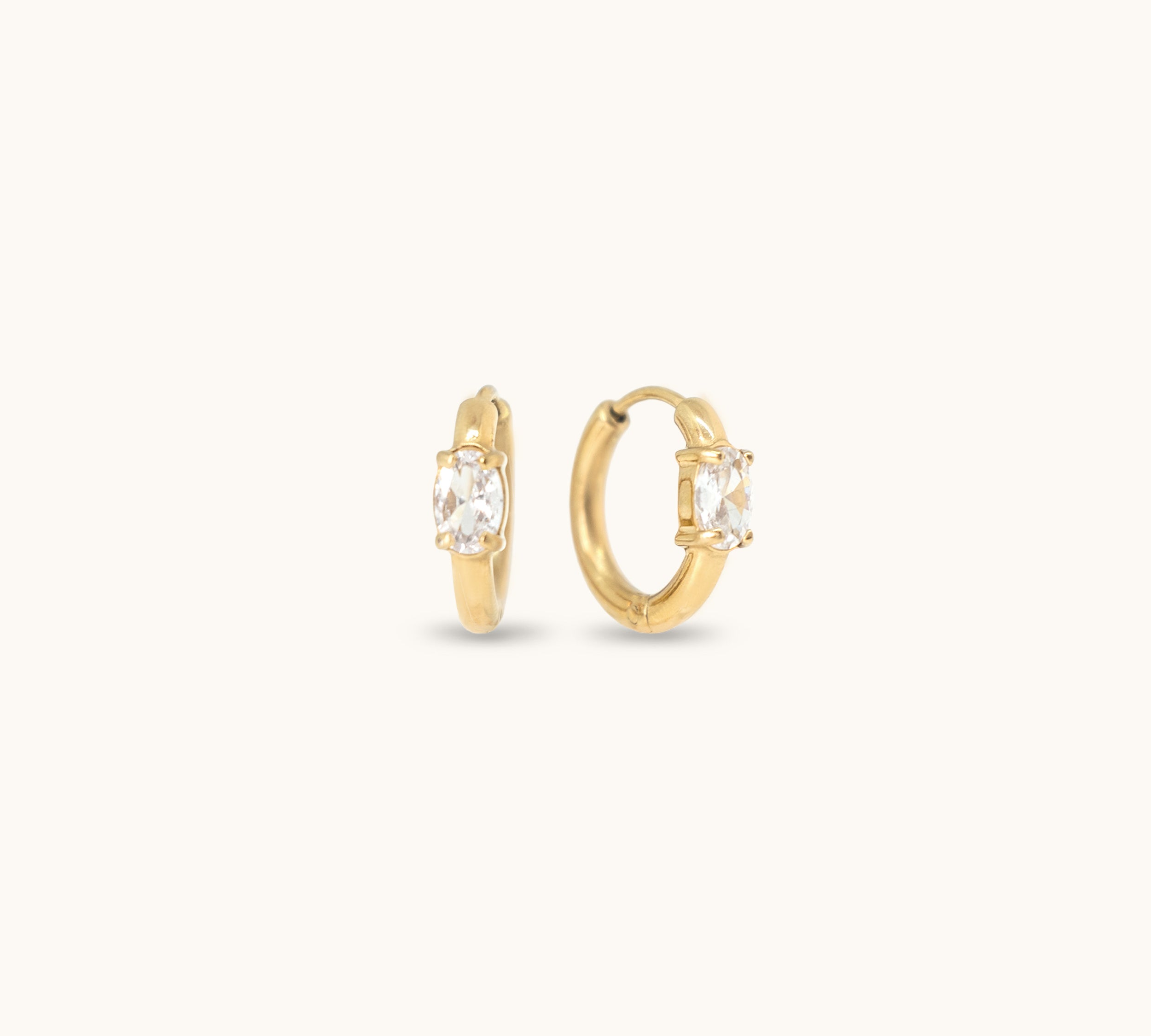 Gold hoop earrings with cubic zirconia stones.