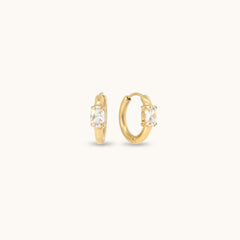 Gold hoop earrings with cubic zirconia stones.